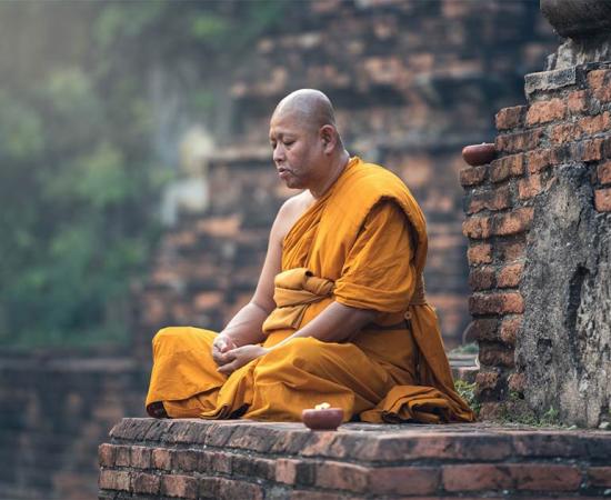 Buddhist monk meditation in temple             Source: Sasint / Adobe Stock