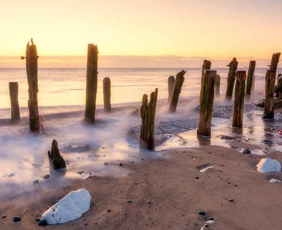Spurn Point beach in East Yorkshire at Sunrise, where remnants of the medieval port town known as Ravenser Odd are believed to reside under the sea. Source: Tim Hill / Adobe Stock