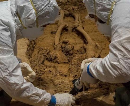 Archaeologists Mary Anna Hartley (left) and Bob Chartrand excavating the bones they believe belong to Gov. George Yeardley.