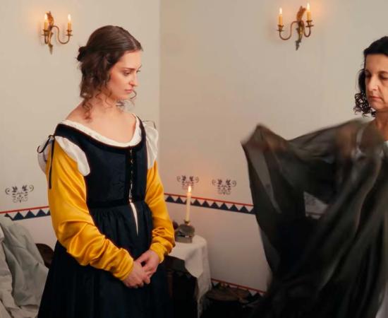 A woman in the Renaissance getting dressed. Source: YouTube Screenshot / CrowsEye Productions.
