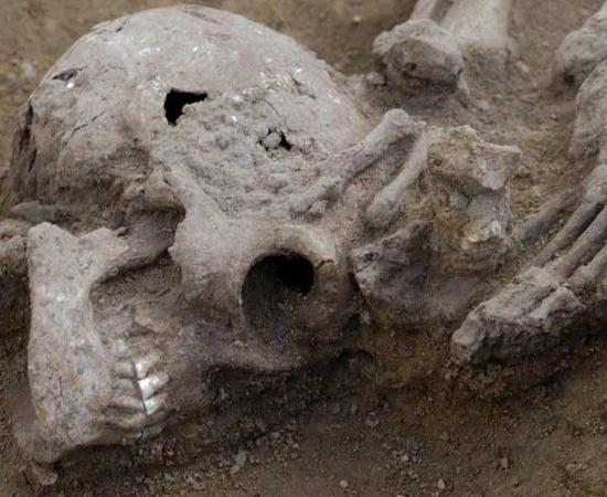 This photo shows one particular body where the head has been lopped off and placed at the feet of the victim found at the Roman burial site, Somersham, UK.  