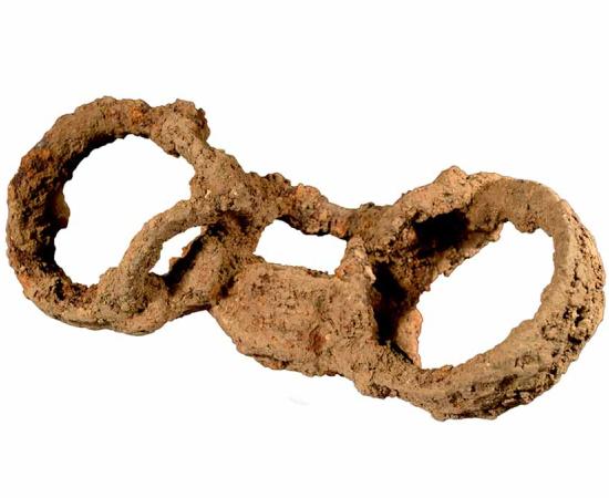 A closeup of the shackles found attached to the Roman slave’s feet in England (Britannia), when this particular slave was tossed in a ditch not far from a “proper” English Roman cemetery.	
