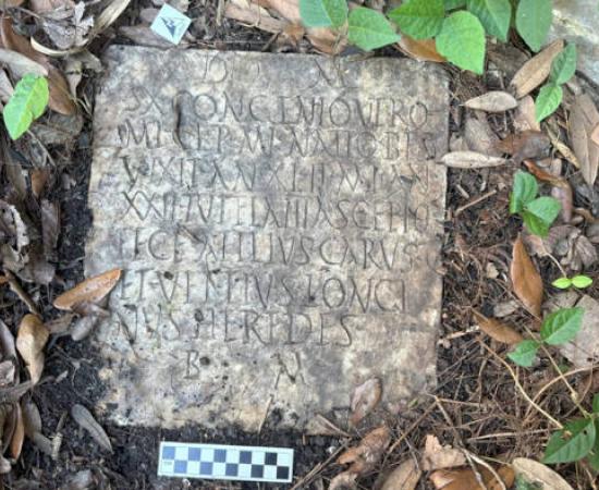 The Roman headstone before removal with its inscription visible.  