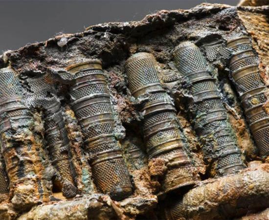 Close up of a selection of the thimbles found among the mysterious artifacts on the Rooswijk shipwreck. The concretions around the artifacts is holding the thimbles together in these straight rows.      Source: © Rijksdienst voor het Cultureel Erfgoed / Historic England