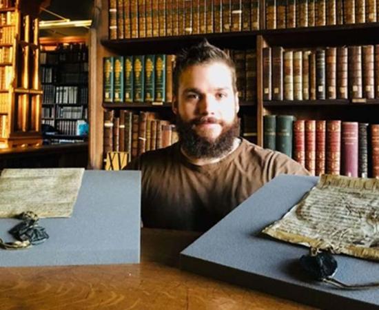 Dr. Benjamin Pohl with the both the royal charter and the Bishop of Durham charter 