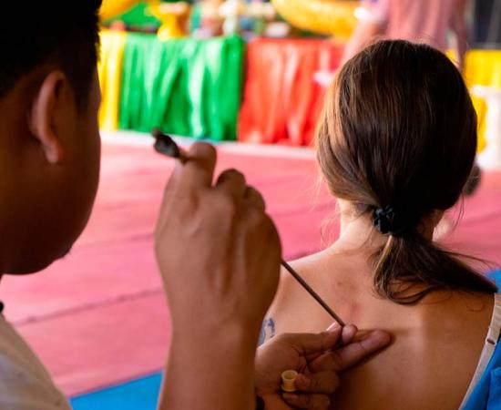 Thai Tattoo Master makes Sak Yant tattoo. Source: Denis / Adobe Stock.
