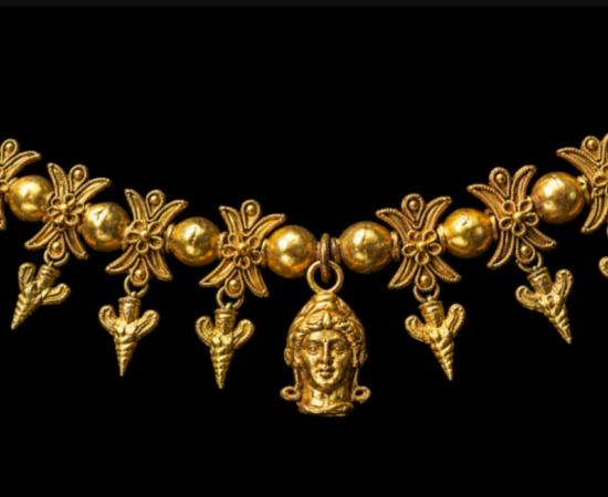 Gold necklace from the North Tomb of the Oguz Kurgan, with its central female head, lotus dividers and suspended pendants.