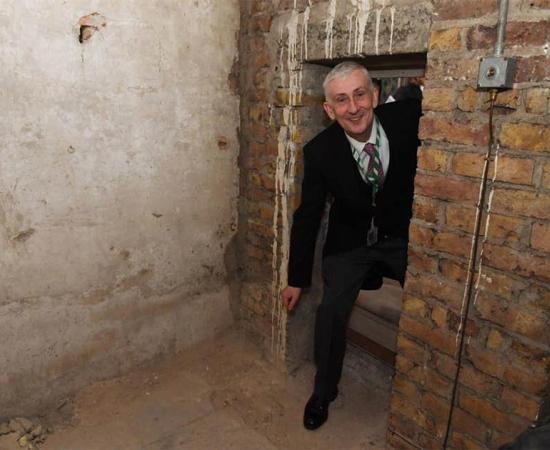 Sir Lindsay Hoyle, Speaker of the House of Commons, poses inside the newly-rediscovered secret passage.       Source: Jessica Taylor / UK Parliament