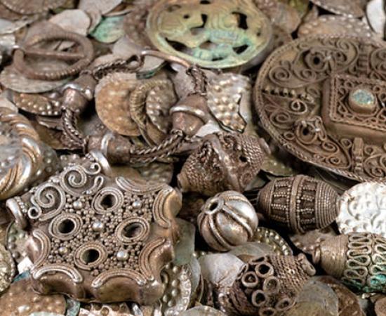 Selection of silver coins, jewelry, and pendants from the medieval hoard discovered near Stockholm.