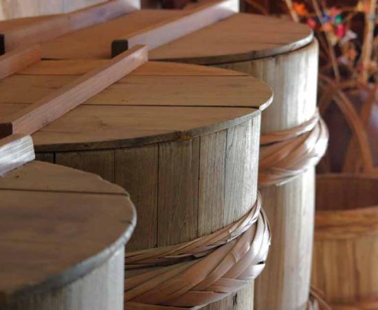 Wooden barrels used in Japanese soy sauce production. Source:  TeTsumi / Adobe Stock.