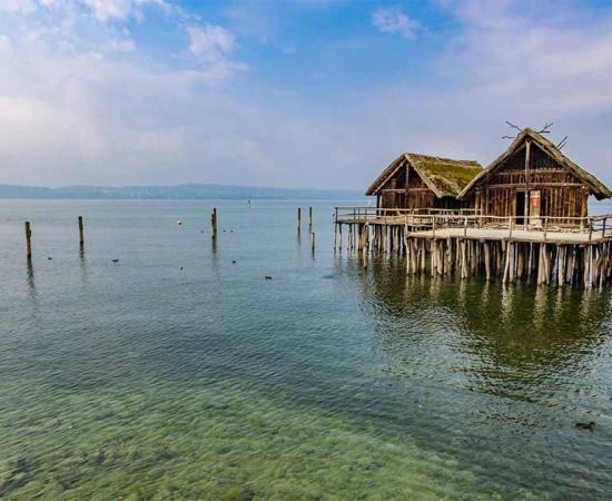 Reconstruction of ancient stilt houses. Source: Takashi Images / Adobe Stock.