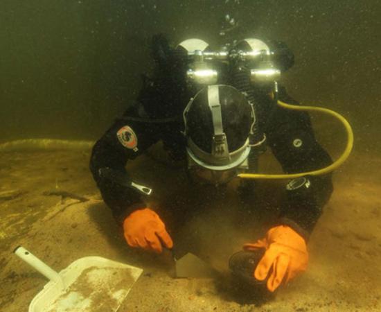 Eveliina Salo taking samples of the hearth structure. 