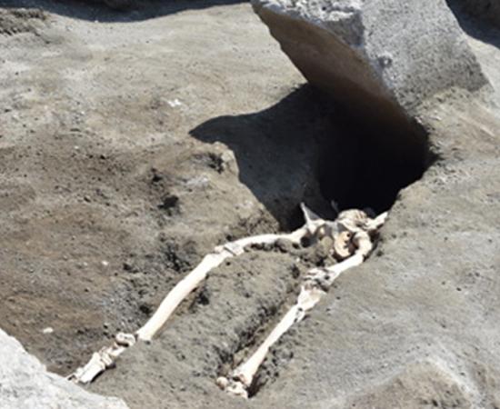 Stone block and decapitated skeleton