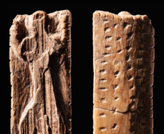 The mammoth figurine from Vogelherd Cave, approximately 40,000 years old, bearing multiple sequences of crosses and dots.