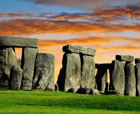 The collaboration of archaeologists and scientists in England led to the 2021 discovery of a large number of Stonehenge pits used for trapping big game about 10,000 years ago! The Stonehenge monument at sunset. 	Source: vencav / Adobe Stock