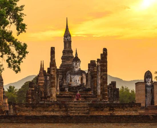 Ancient pagoda and big buddha at Sukhothai Historical Park, the birthplace of the Sukhothai Kingdom. Source: somrakjendee / Adobe Stock.