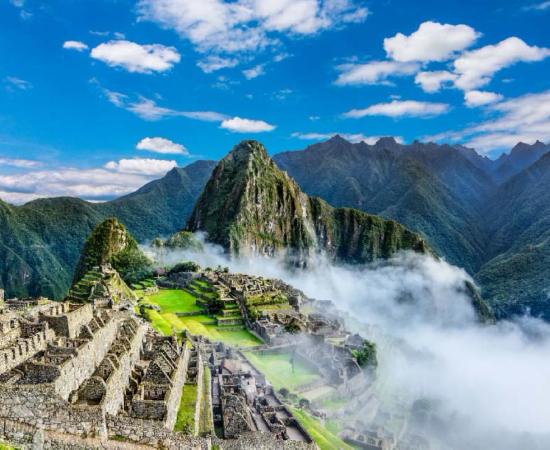 Overview of Machu Picchu, agriculture terraces and Huayna Picchu peak in the background   Source: davidionut / Adobe stock
