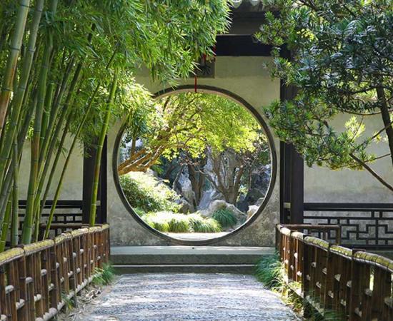 Circular gate in the Suzhou gardens. Source: rudiuk / Adobe Stock 
