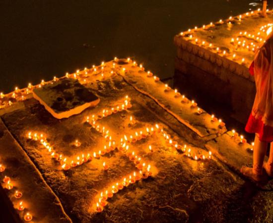Swastika symbol decoration of clay lamps (diya) in Varanasi, India on the festival of Dev Diwali. Source: ShishirKumar / Adobe Stock