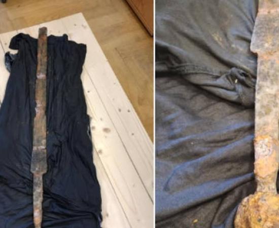 Two views of the medieval sword recovered from the Vistula River in Warsaw, displaying characteristic features including a spherical pommel and cross marking on the handle. 