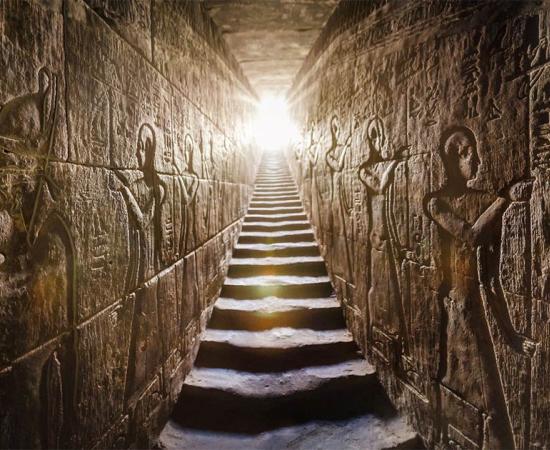 Temple of Edfu passage with glowing walls of Egyptian hieroglyphs on either side.	Source: Konstantin / AdobeStock
