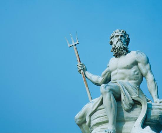 Ancient stone statue of mighty god of the sea and oceans Neptune (Poseidon) with trident.	