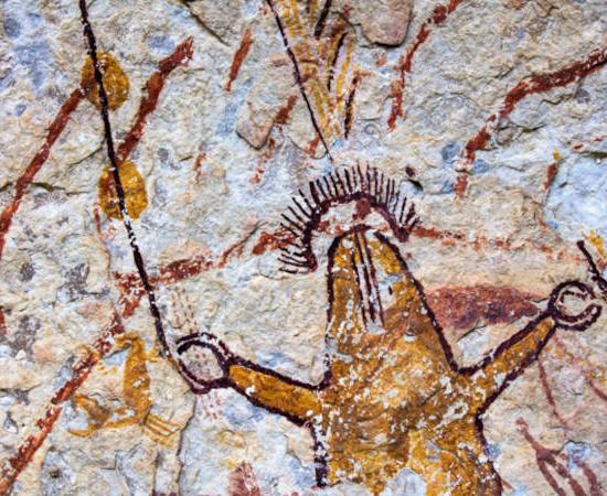 Ancient polychromatic Pecos River style rock art mural showing humanlike figures with elaborate symbolic elements.