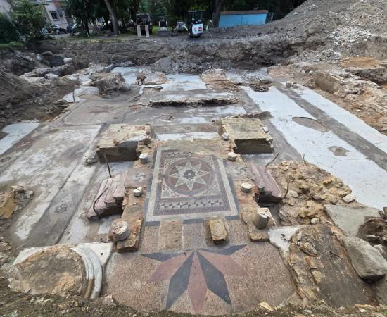 Great Synagogue of Vilna reveals colorful terrazzo flooring with geometric floral decoration surrounding the synagogue's central bimah 