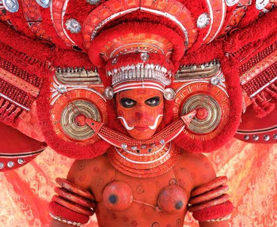 Dancer at a traditional Theyyam ceremony, India. Source: Dietmar Temps / Adobe Stock.