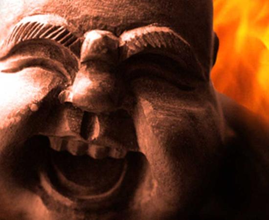 A statue of a Kitchen God - CC BY-NC-SA 2.0 with flames