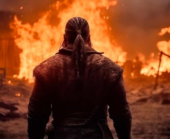 Viking raider surveys his work at a burning medieval village.	Source: ParinApril/Adobe Stock