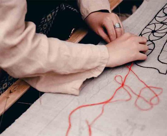 A Scandinavian woman working on a embroidery pattern modern times, which must have been quite similar to Viking embroidery in the Viking Age. 