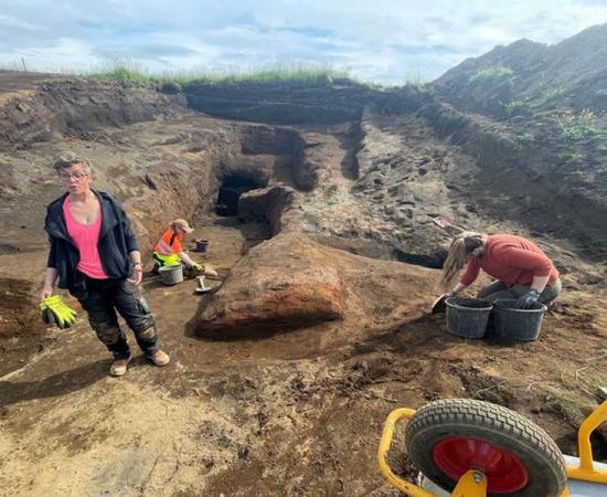 Archaeologist Kristborg Þórsdóttir standing at the site of the vast system of Viking era caves.  Source: Sigurjon Olason / Visir