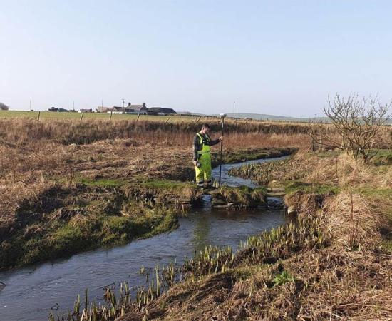 Top image: The Orkney River is part of the recently discovered Orkney Viking waterway. The researcher shown in this photo is carrying remote-sensing geophysical mapping equipment.           Source: Express and Star