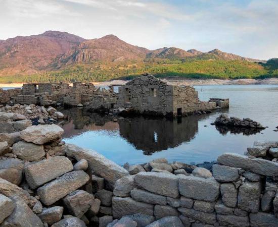 The village Vilarinho da Furnas inside the national park Peneda-Geres in Portugal. It is only visible at low water levels. Source: Carlos Caridade/Wirestock Creators/Adobe Stock