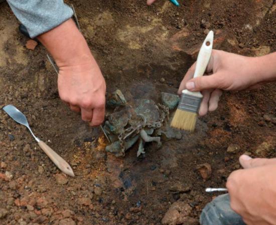 The moment of the discovery of the wind chime in Viminacium.  Source: Ilija Danković, Archaeological Institute