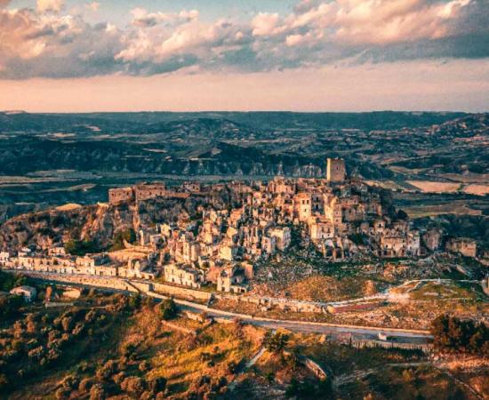 These abandoned cities from across the globe are the remnants of a different era. Pictured: Aerial view of Craco, Basilicata region of Italy. Source: Pavlo Glazkov / Adobe Stock