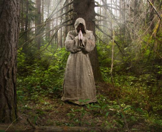 Monk in the forest Credit: Demian / Adobe Stock