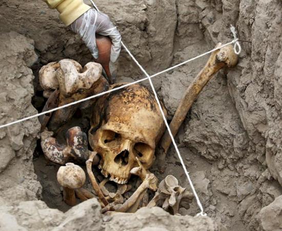An archaeologist working in one of the tombs found at the Huaca Pucllana archaeological site in Lima, Peru. 