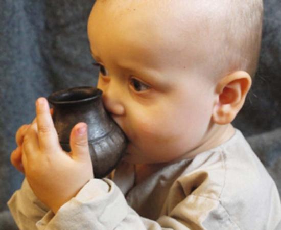 Infant drinking from a replica feeding vessel similar to the type investigated in the new study. Source: Helena Seidl da Fonseca, University of Vienna