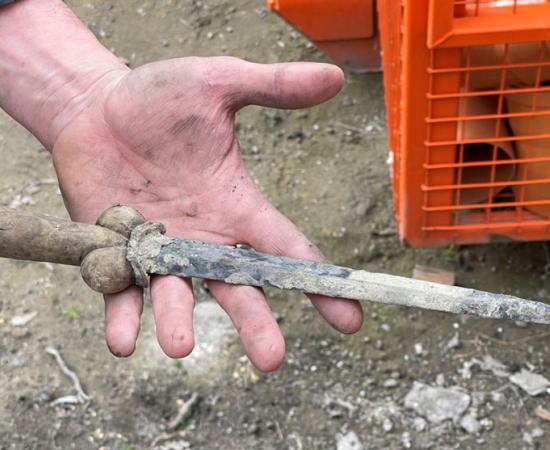 A researcher holding the bollock dagger that was found at Ypres, Belgium.	Source: VRT