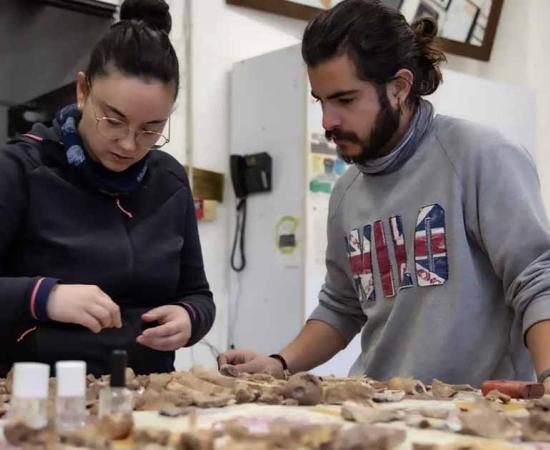 Archaeologists analyzing the remains from excavations at the Cova dels Xaragalls burial cave in Catalonia. Source: IPHES-CERCA