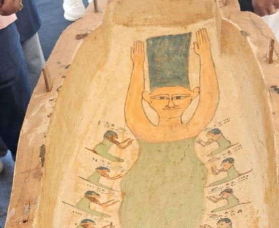 A carved and painted wooden coffin