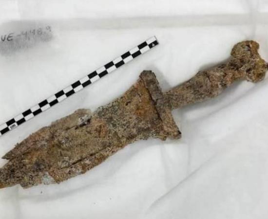 The first century BC dagger, rusted but still intact, that was removed from the back and burial of the second or third century Roman soldier.