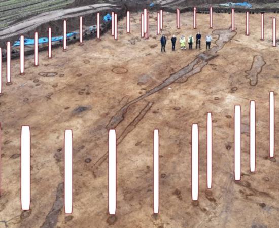 Photo of timber circle site in Denmark, with overlay showing how it would have looked with posts installed 4,000 years ago.