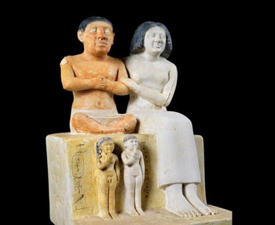 There is much evidence of dwarfs in Egypt. Here, a group statue of the dwarf Seneb and his family at the Egyptian Museum in Cairo. The statue was found in a naos in his mastaba tomb in Giza. Seneb is represented seated, with his legs crossed, beside his wife who embraces him affectionately. His wife is of regular height. 	Source: Ministry of Tourism and Antiquities