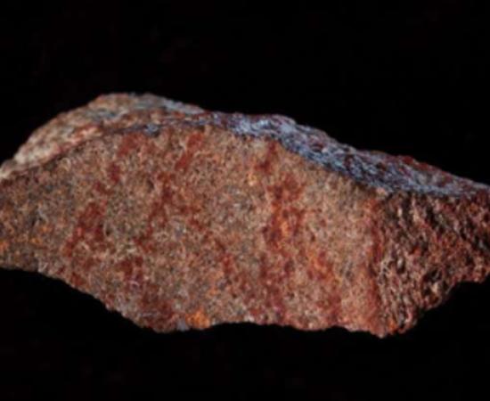 A Blombos Cave with ochre pencil on silcrete stone thought to be the earliest drawing. 