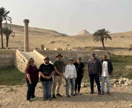 The research team stands in front of the pyramid of Unas’s Valley Temple, which acted as a river harbor in antiquity. Source: Eman Ghoneim/Nature