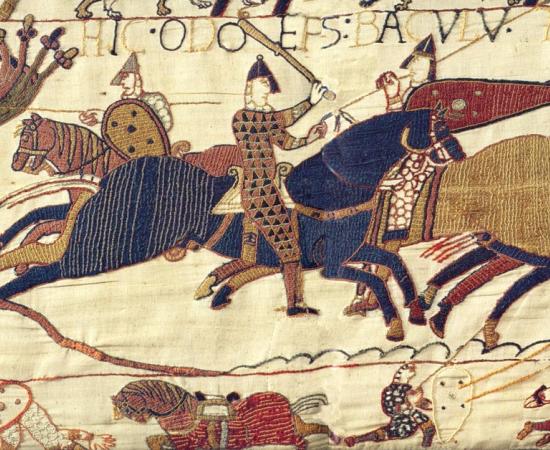 : A segment of the exquisite Bayeux Tapestry. In this scene Odo, Bishop of Bayeux (with raised club), half-brother to William the Great, rallies the troops in the Battle of Hastings in 1066.