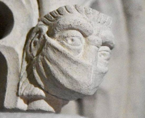 A figure wearing a face mask in St Albans Cathedral